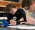 male student writing on paper