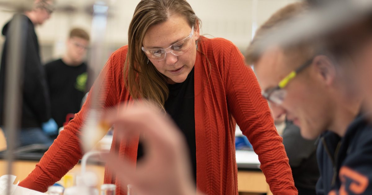 Female professor looking at chemicals