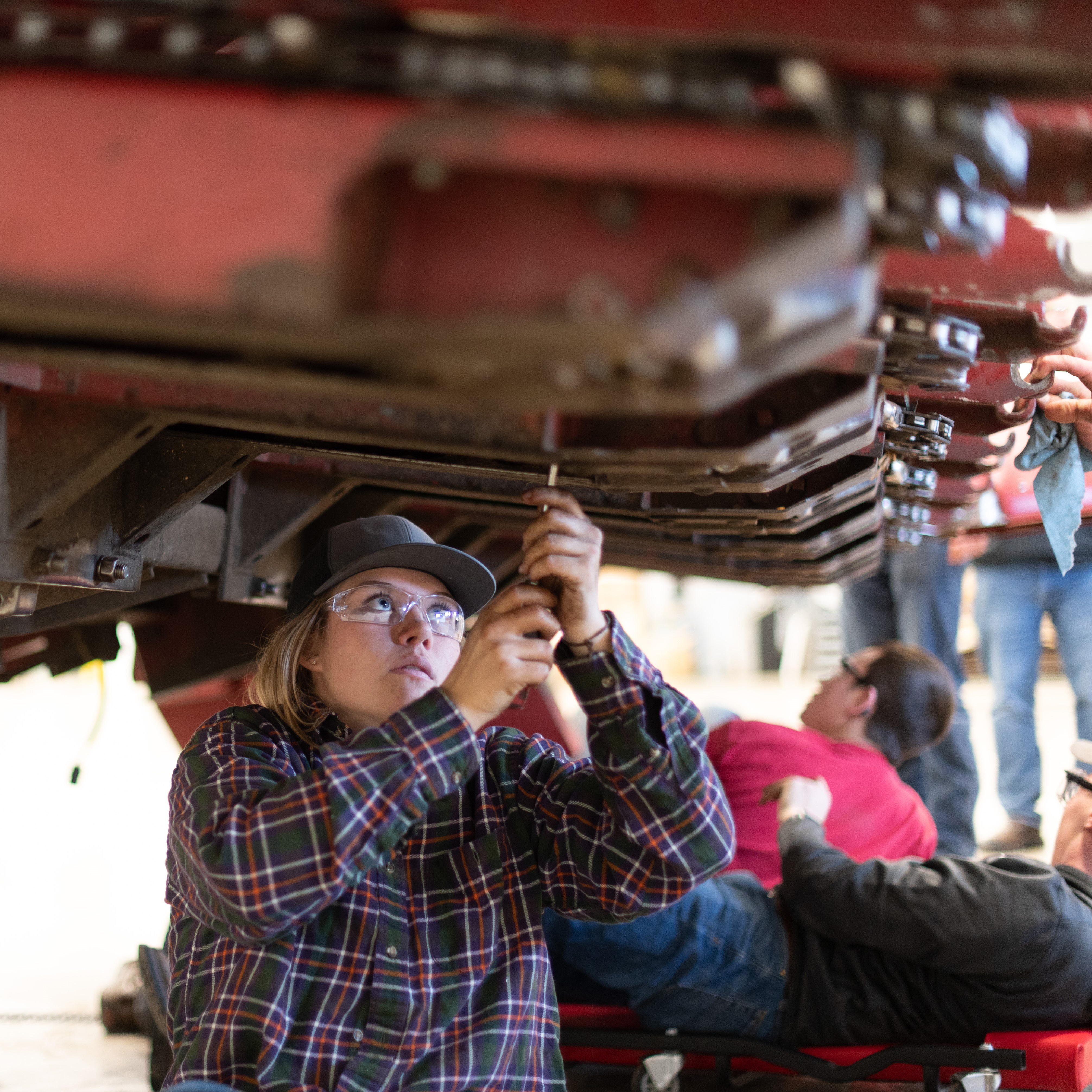 Female student works on machinery