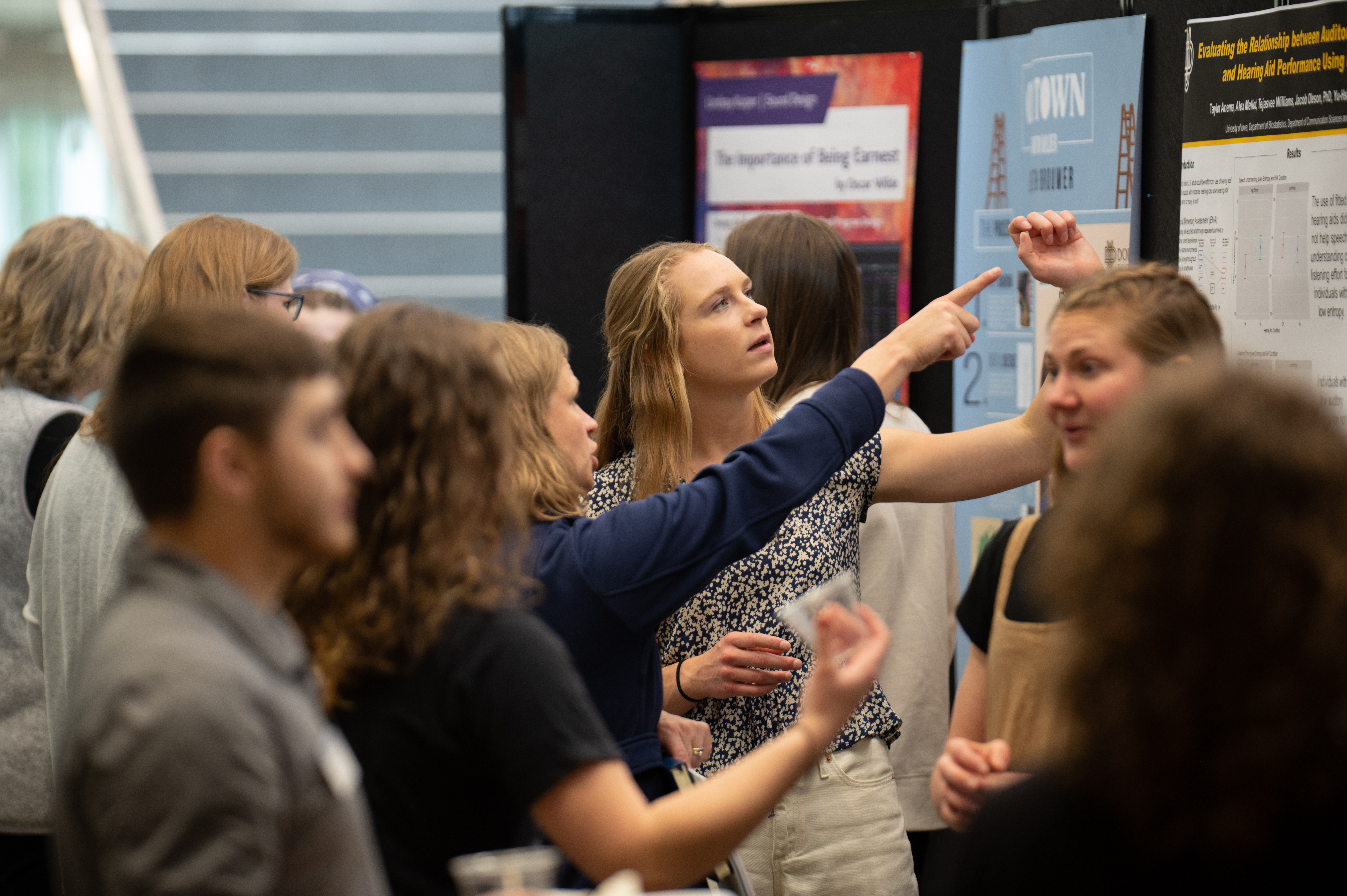Students pointing at a fact on the poster