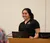 Female student speaking on a podium with her computer