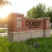 Sunset behind brick and mortar "Dordt University" sign