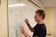 Male student writing on whiteboard