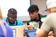 Male student pointing to his classmates screen