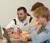 Male teacher helps student on his computer