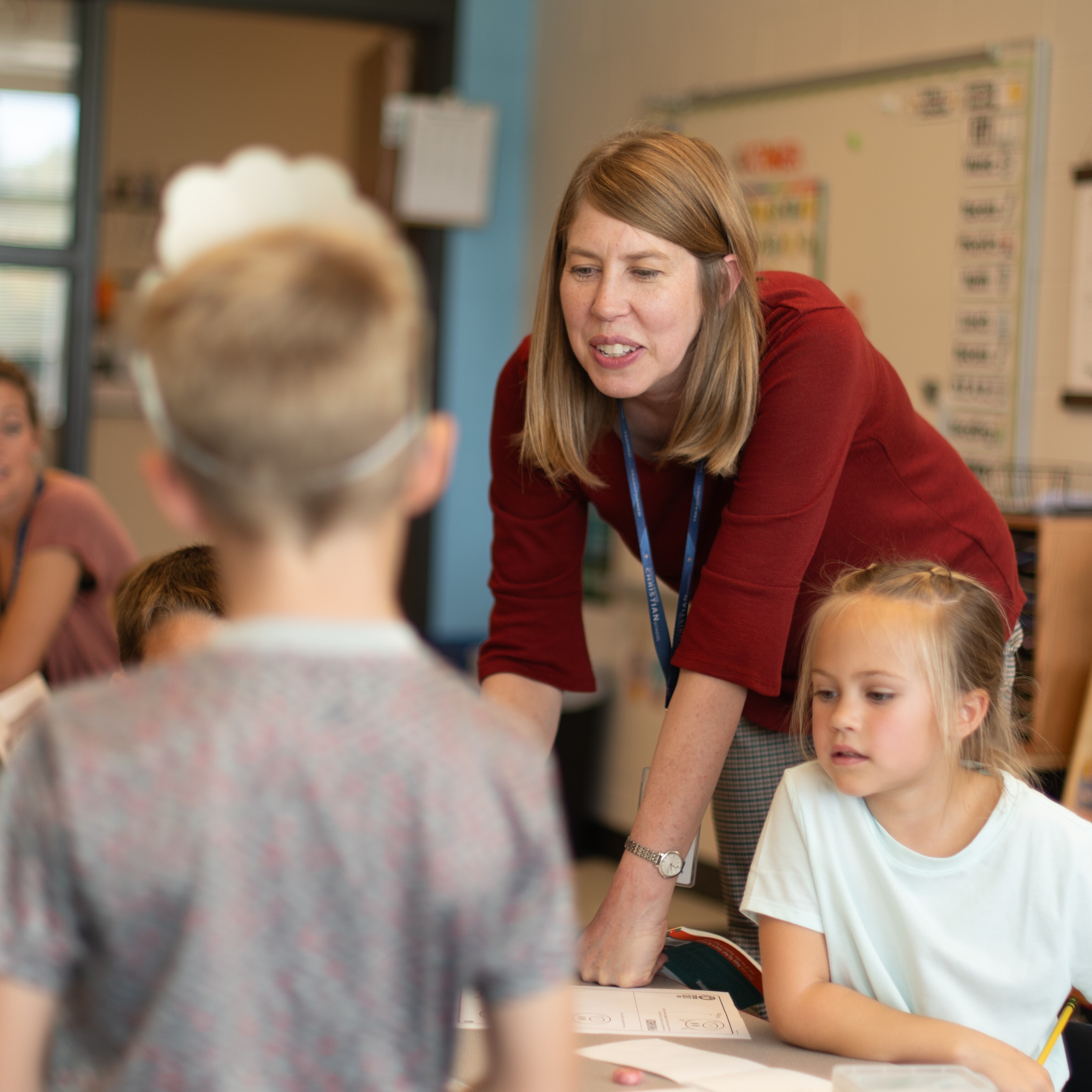 Female teacher helps her students