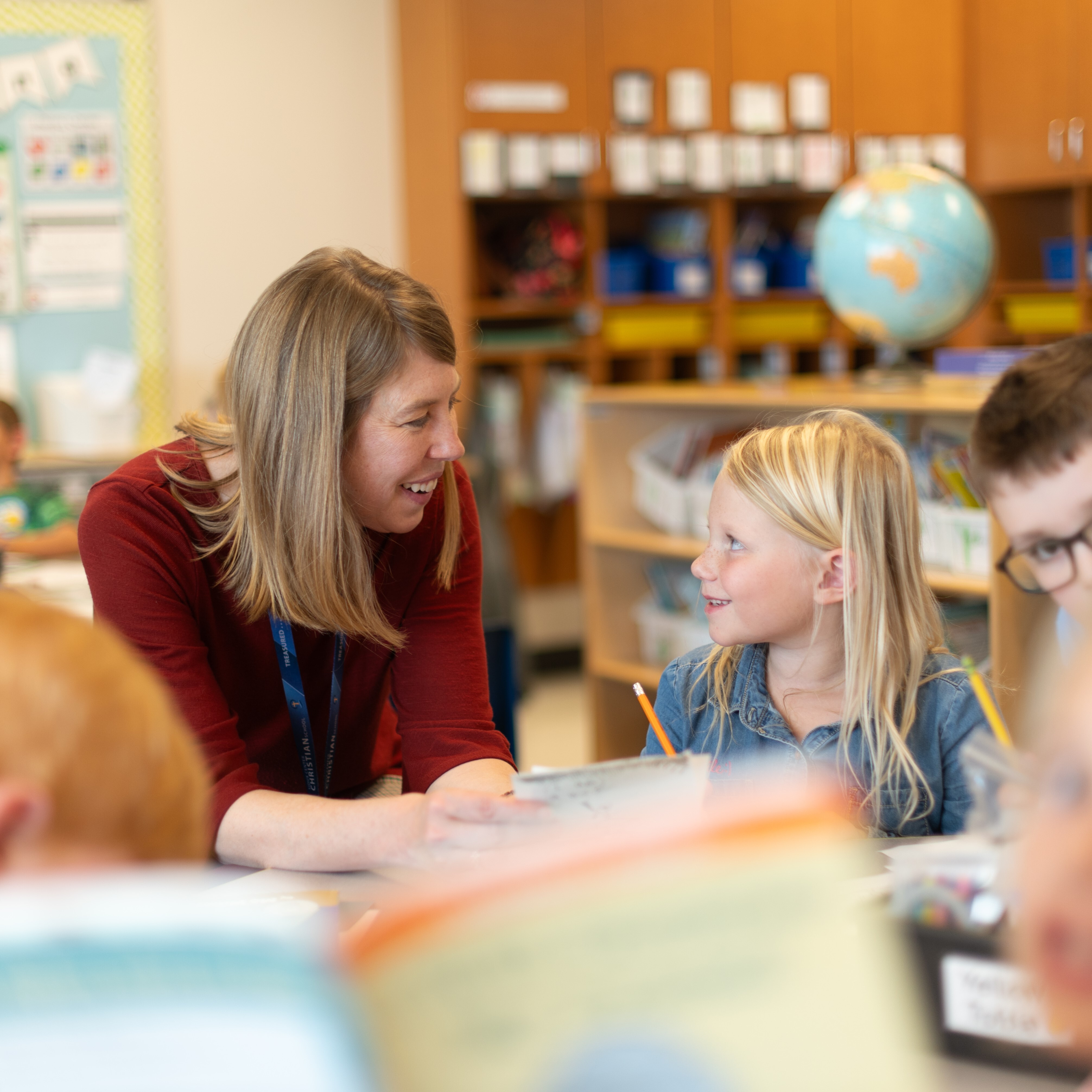 Teacher helping her student