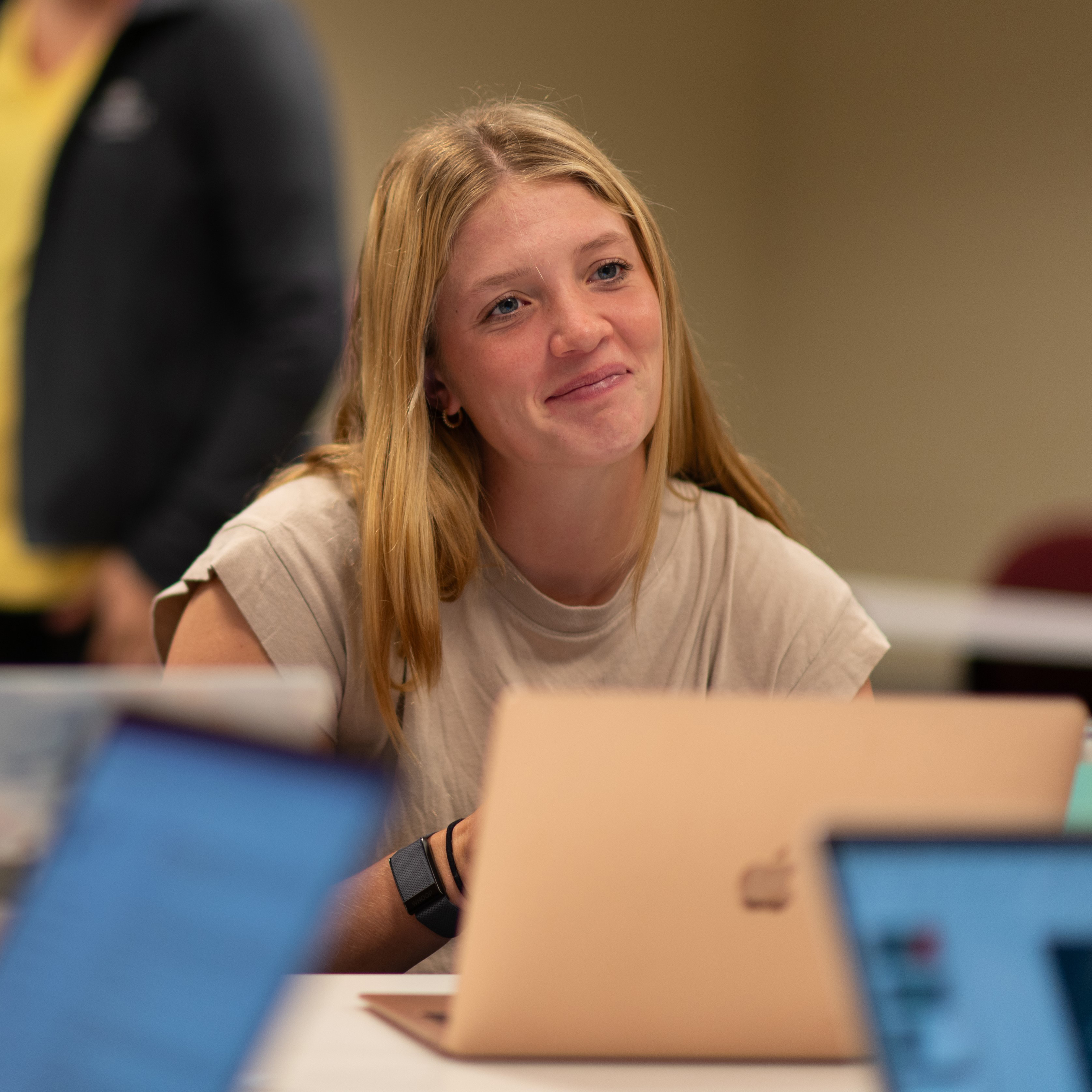 Female student looks up from her computer