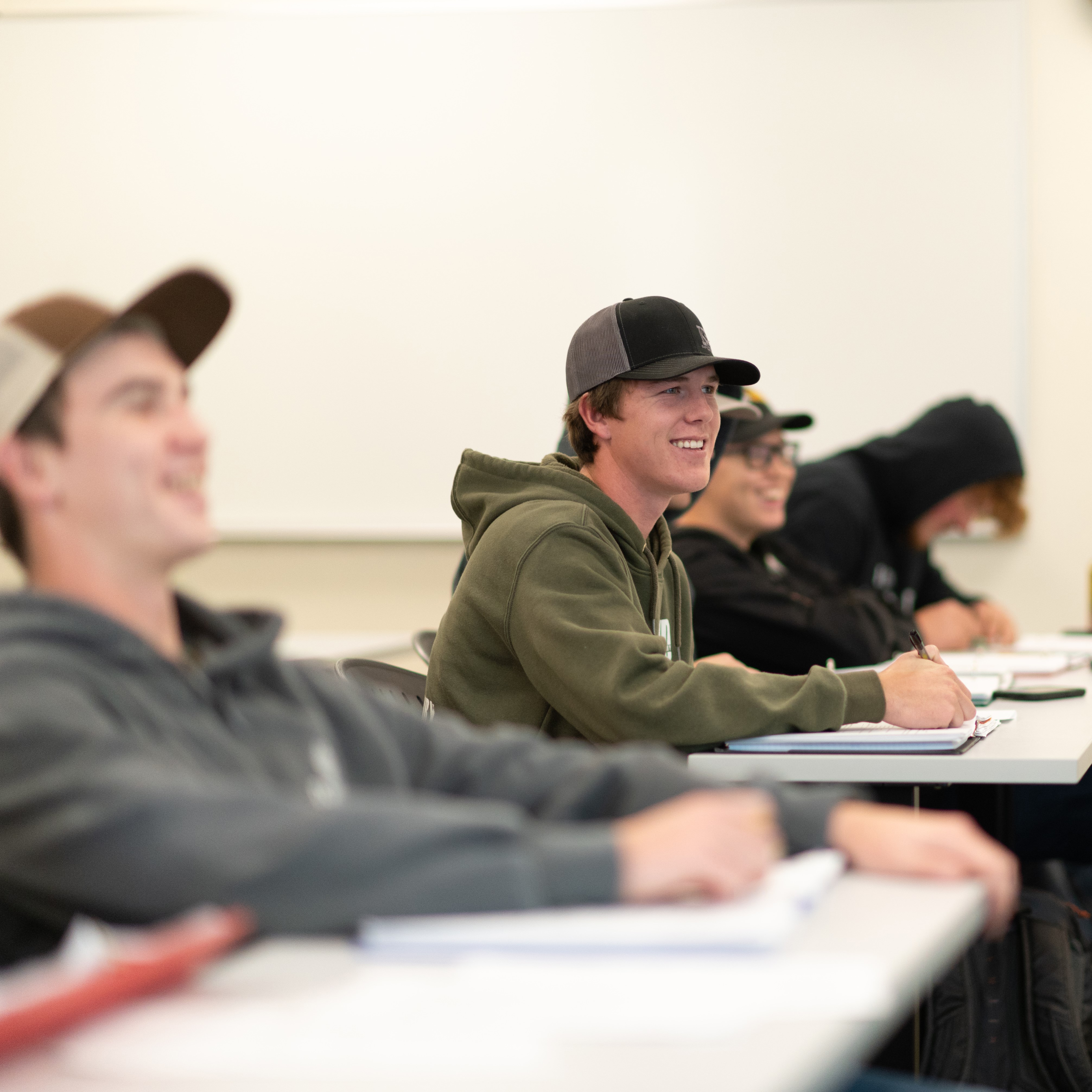 Male student smiles in class
