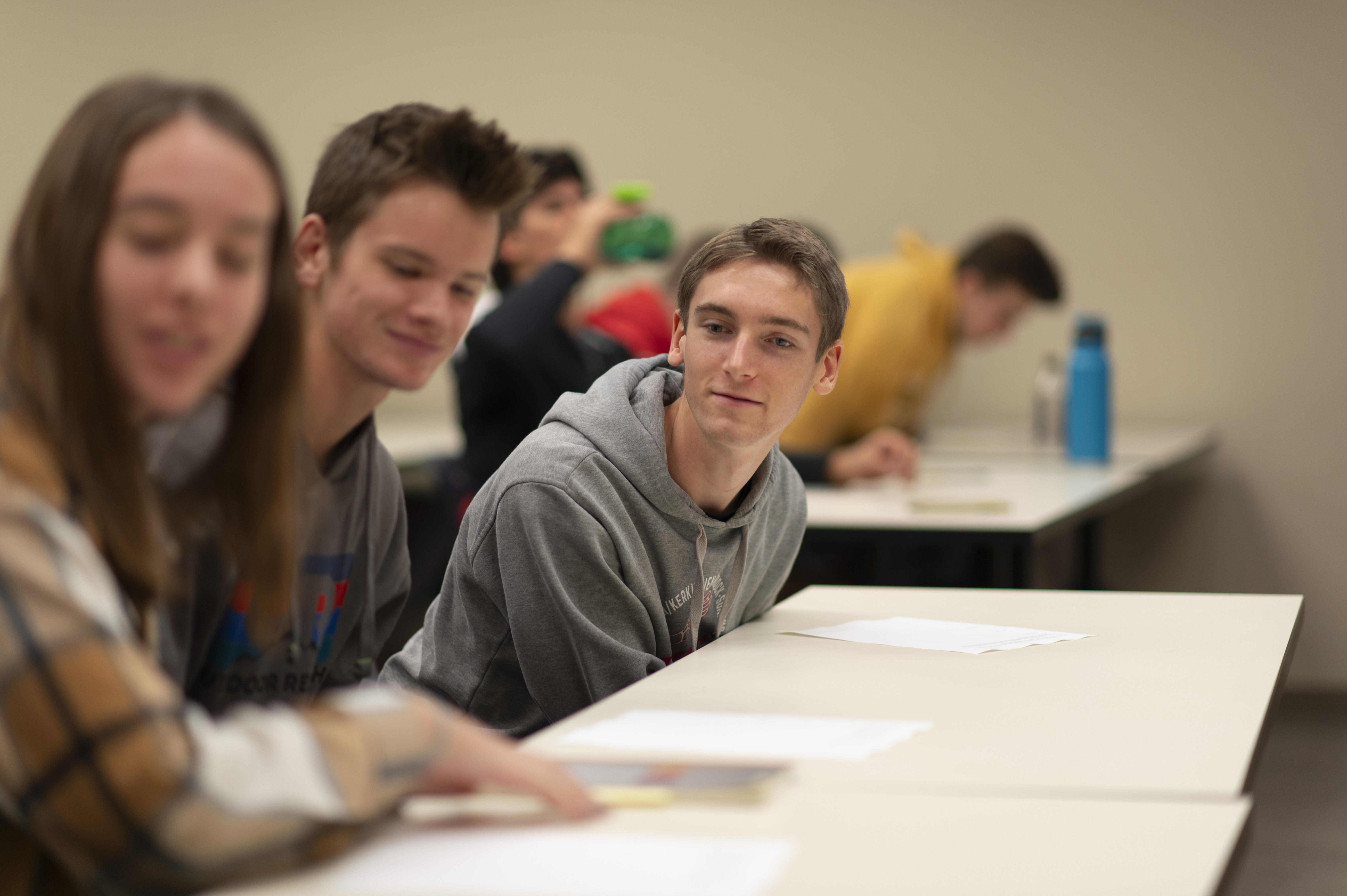 Male student checks out what his classmates are doing