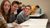 Male student checks out what his classmates are doing