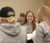 Female student smiles as she spots the camera
