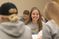 Female student smiles as she spots the camera