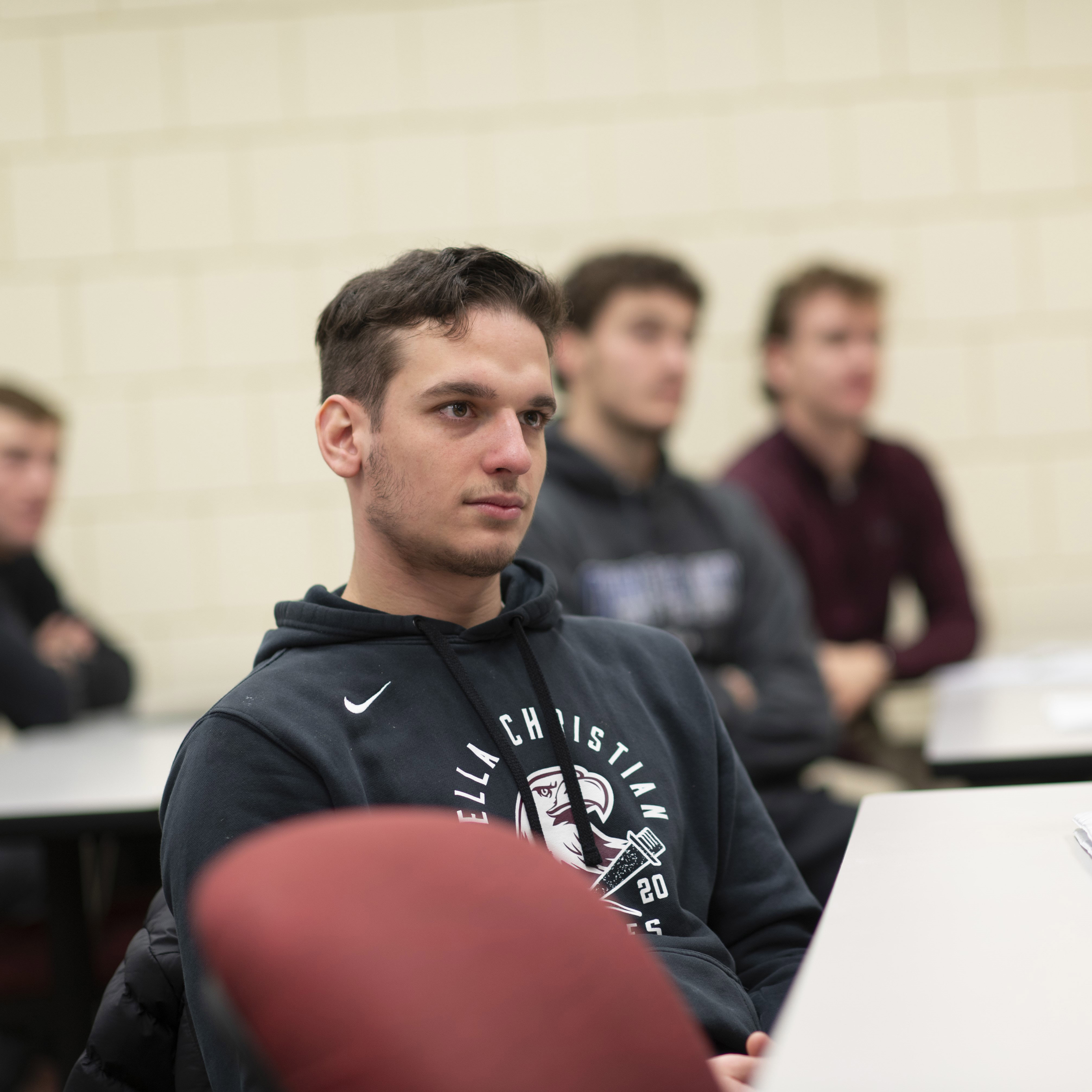 Male student listens in class