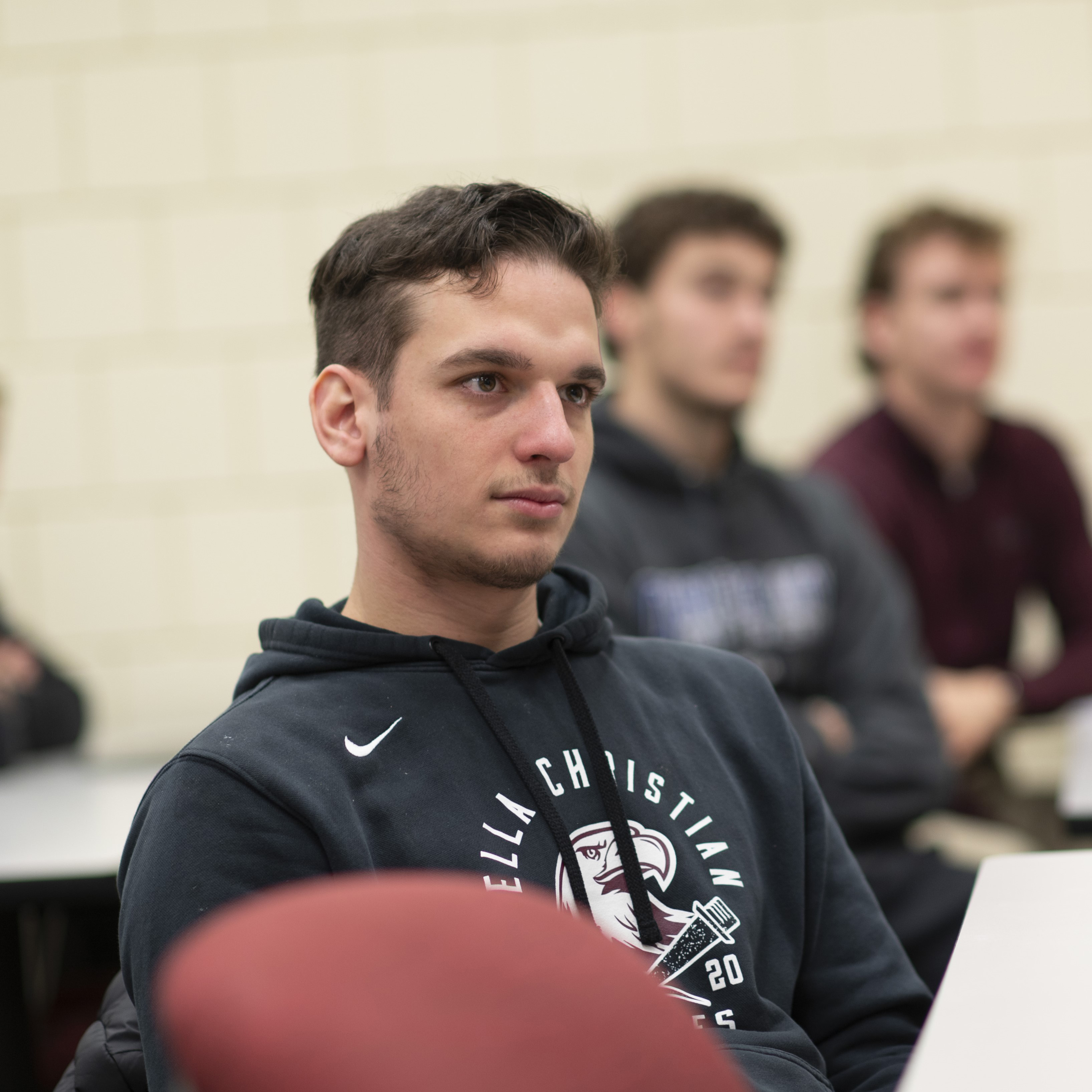 Male student sitting in class
