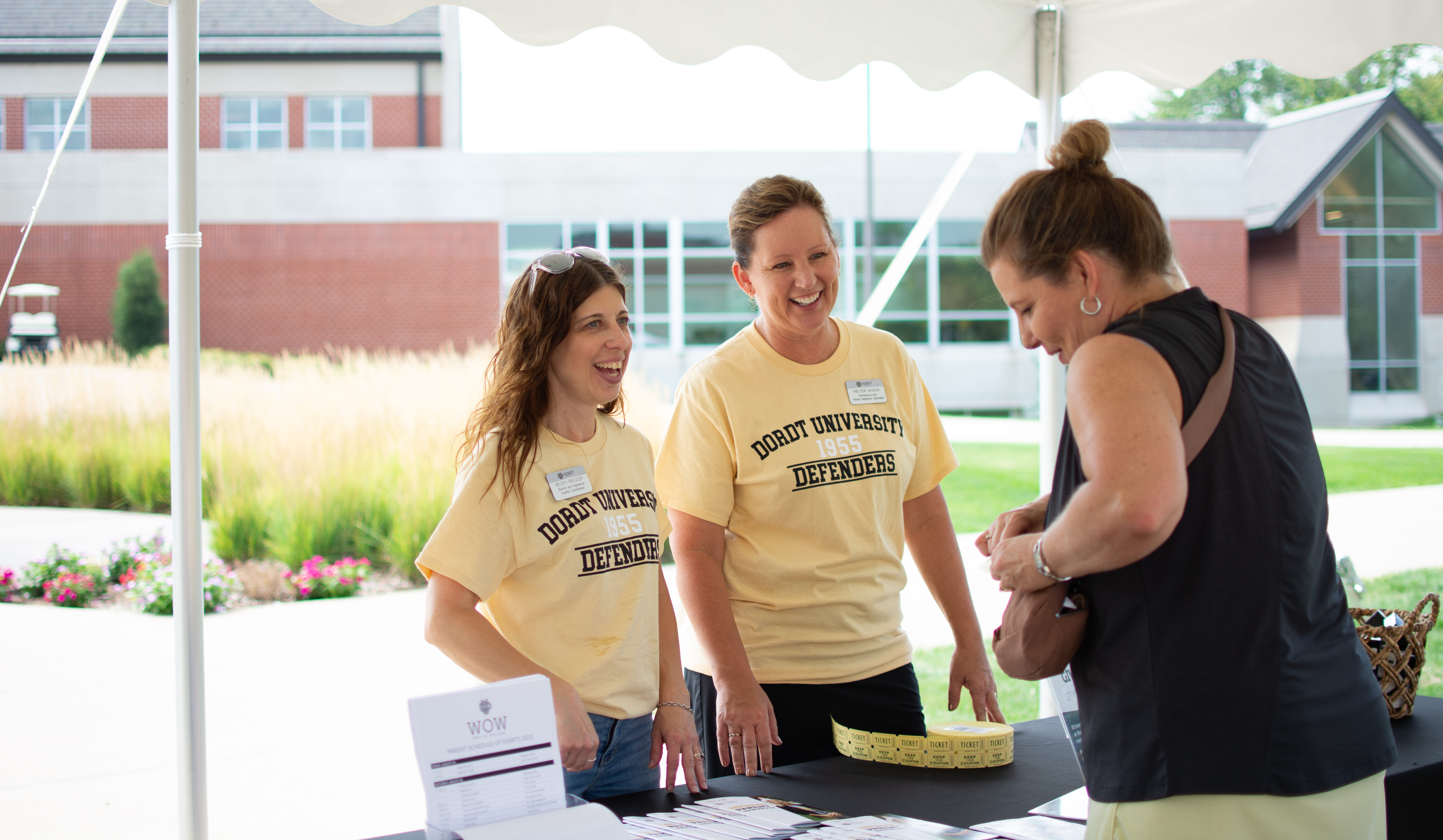 Signature Events Coordinator Becky Ringsby and Admissions and Parent Relations Specialist Melodie Bajema greet a parent during Week of Welcome.