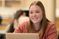 Female student glances up from her computer