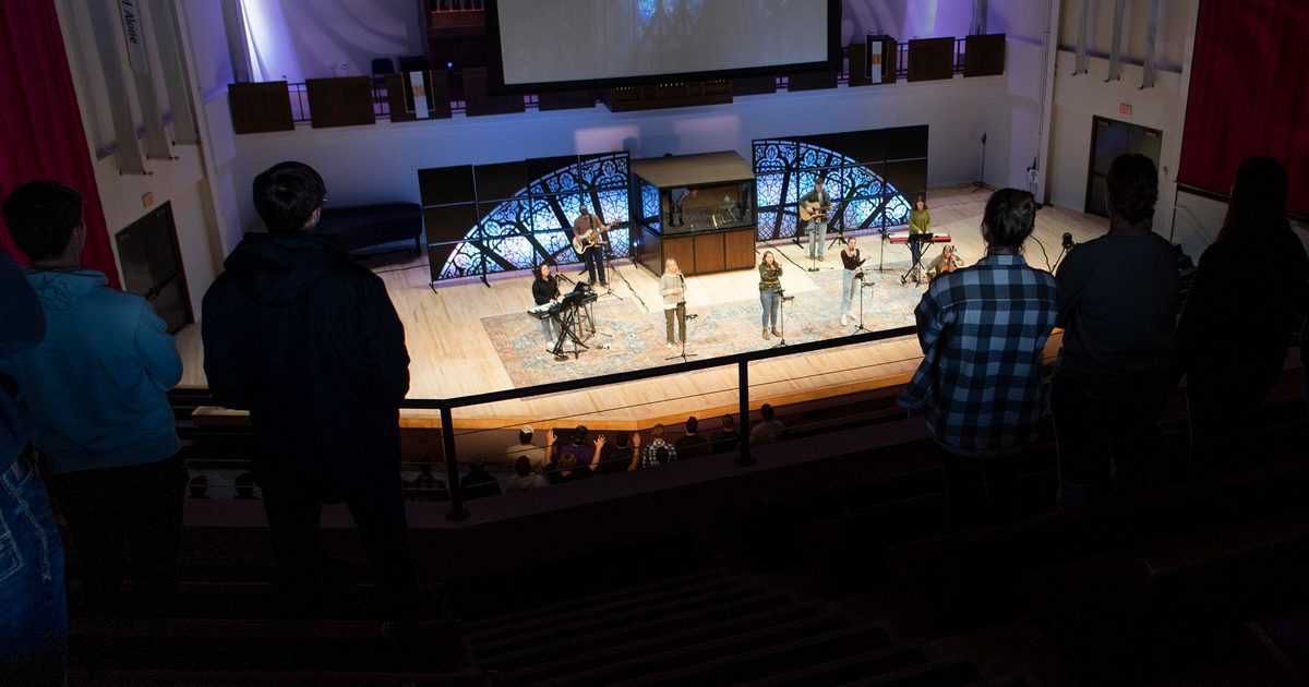 Performers on stage from the view of people in upper balcony