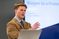 Male student speaks in front of class