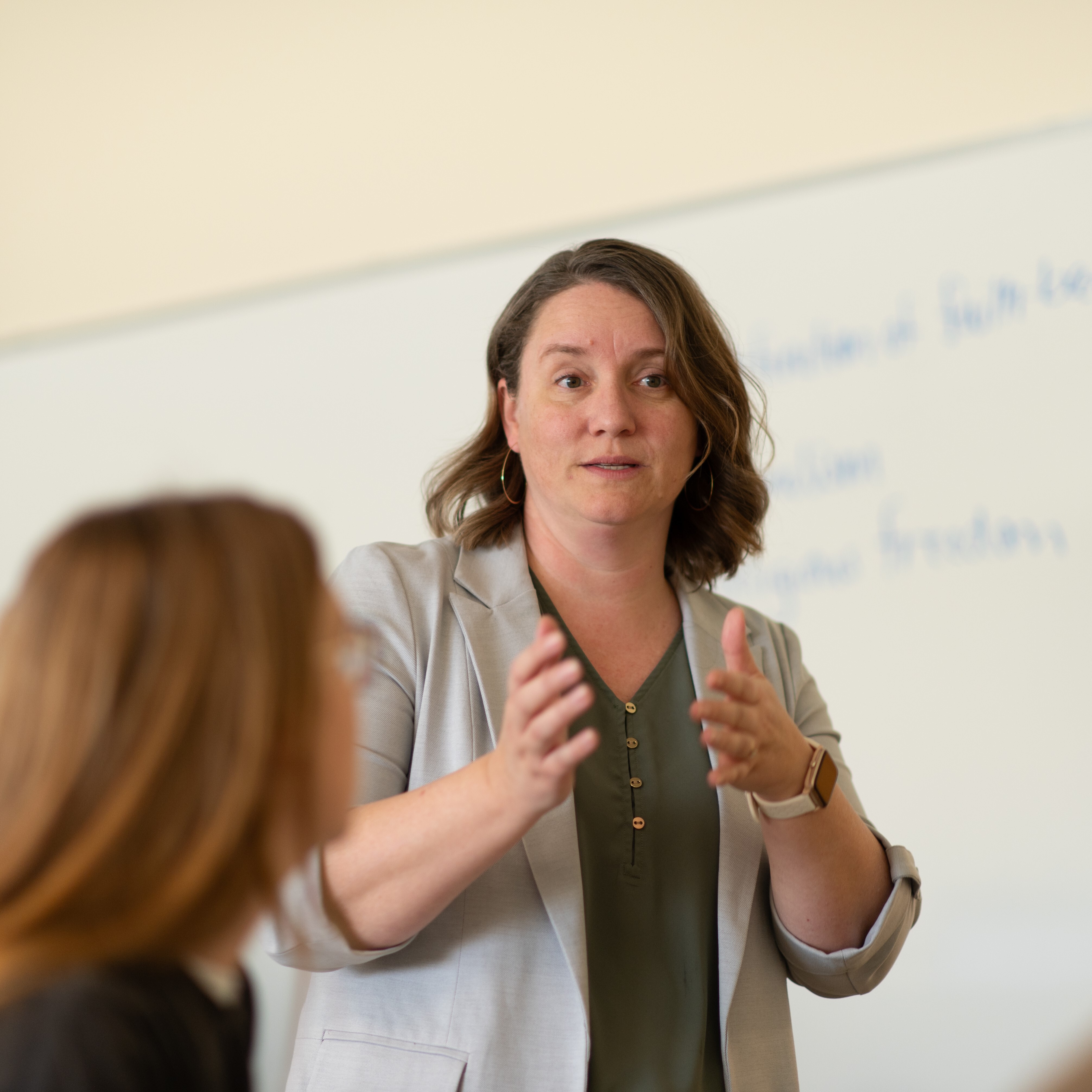 Female professor teaching Infront of class
