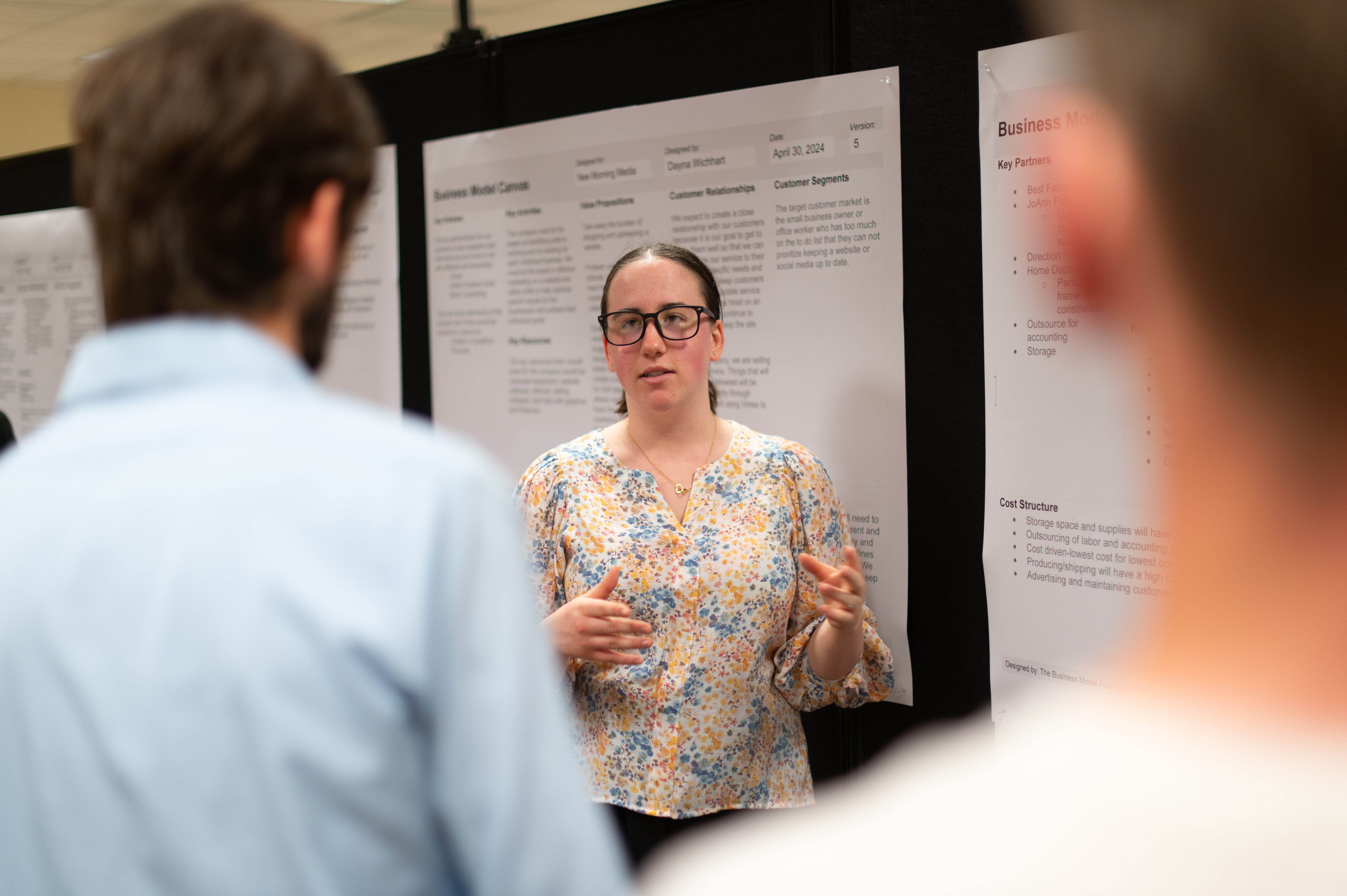 Female shares her presentation in front of other students