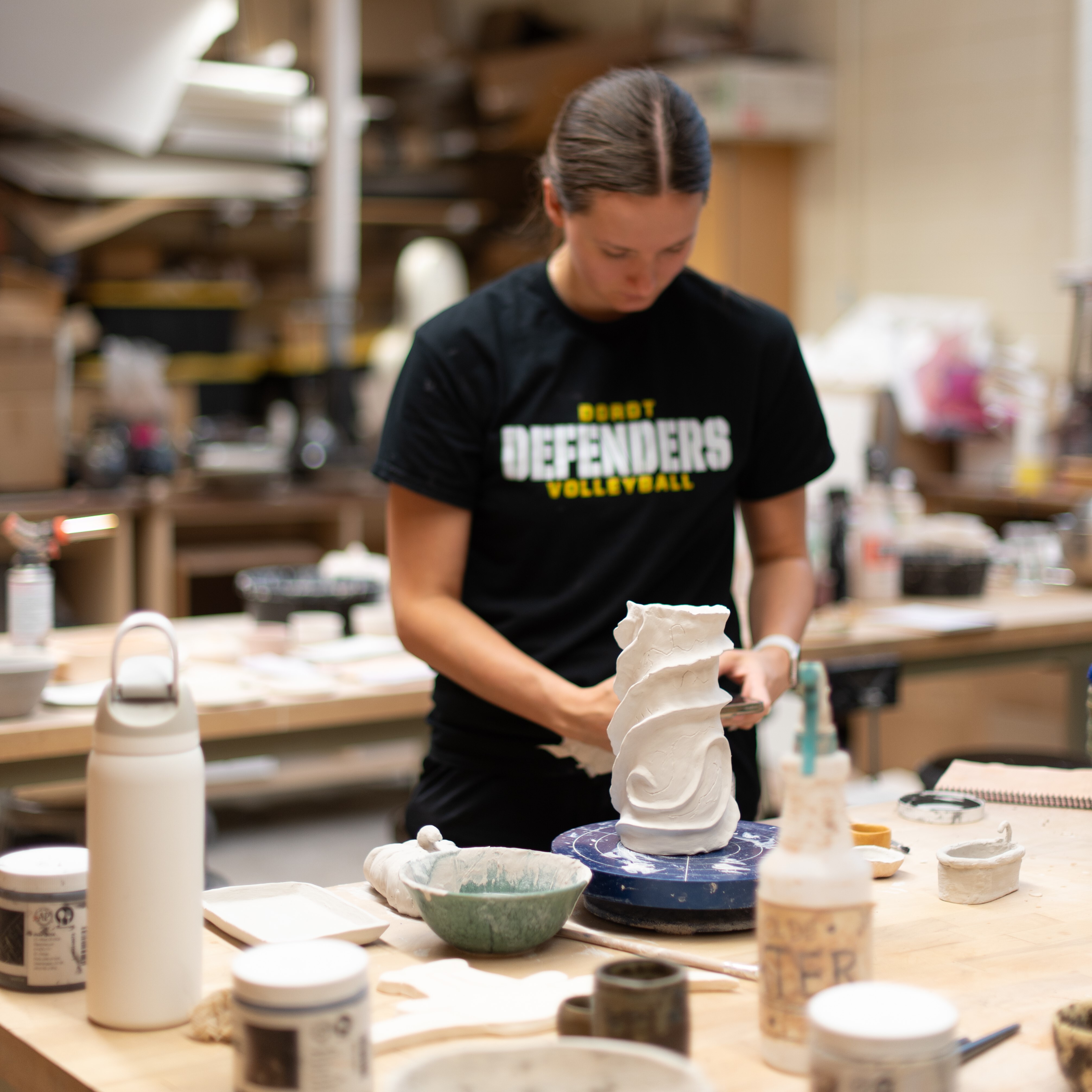 Female student works with clay