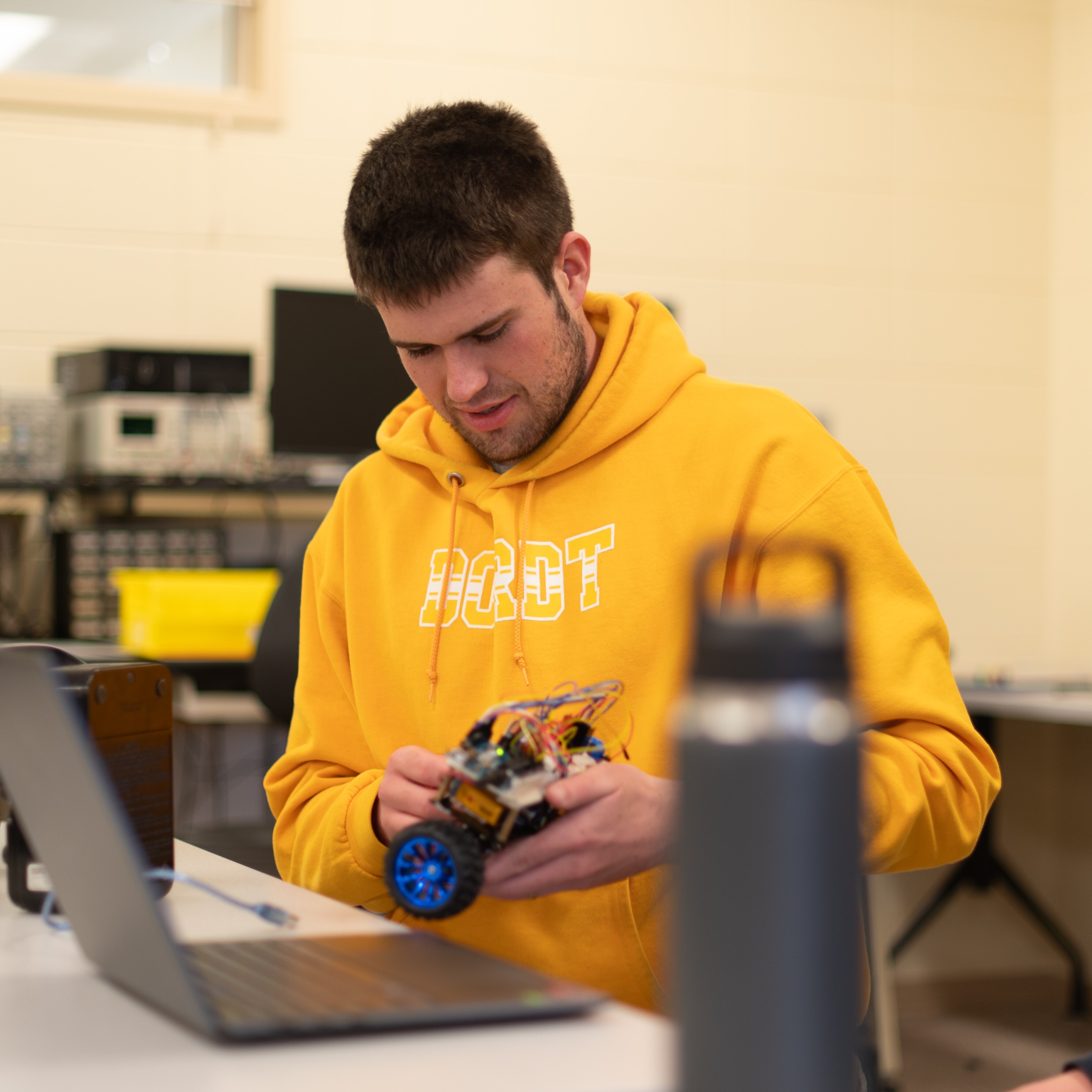 Male student working on a robot