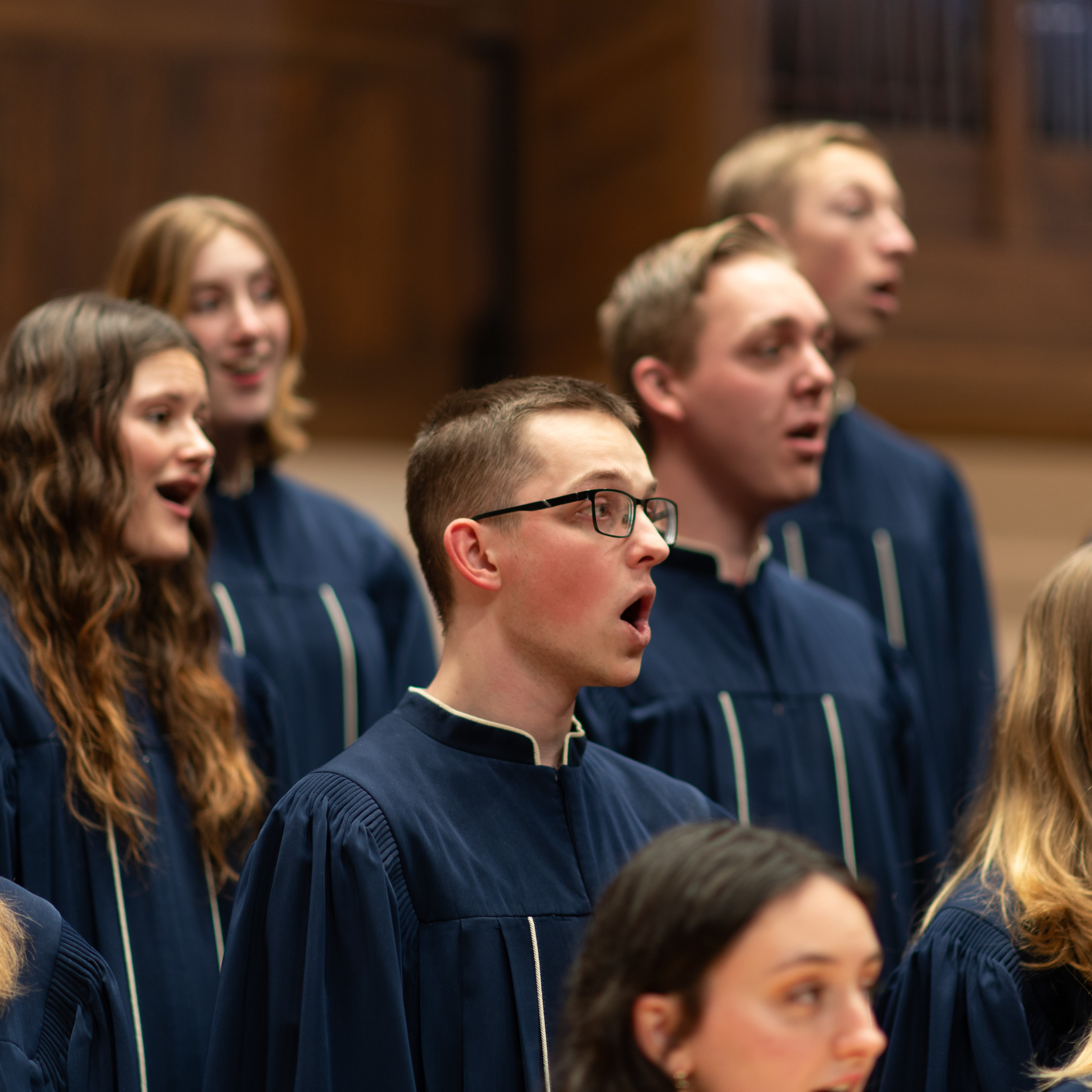 Male student singing in a choir