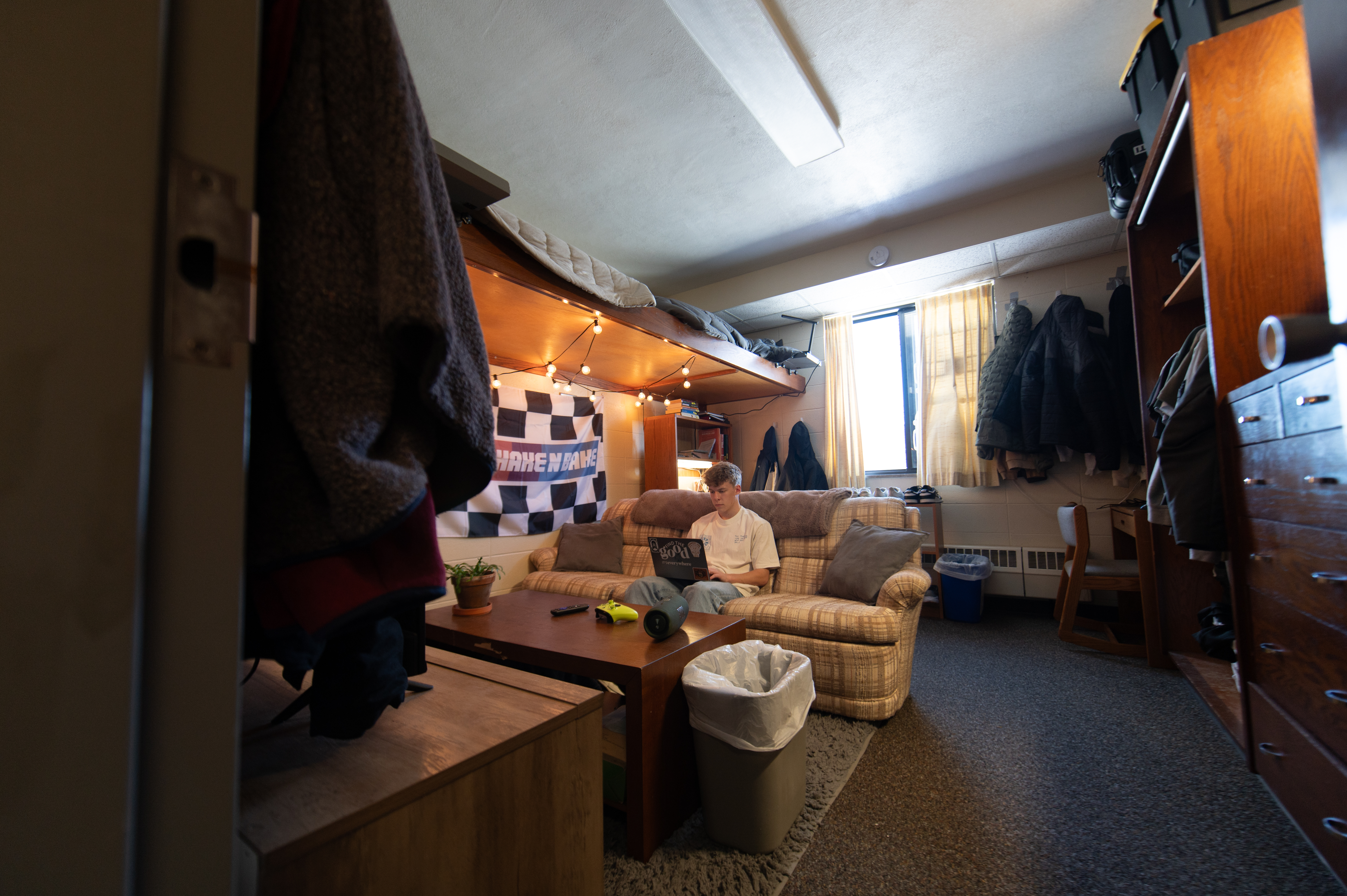 Male student sitting in his dorm room