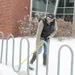Man shovels snow around bike rack