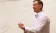 Middle-aged man lectures in front of whiteboard