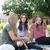 Three Ƶstudents sitting outside having a conversation