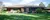 Ranch home with blue skies and green grass