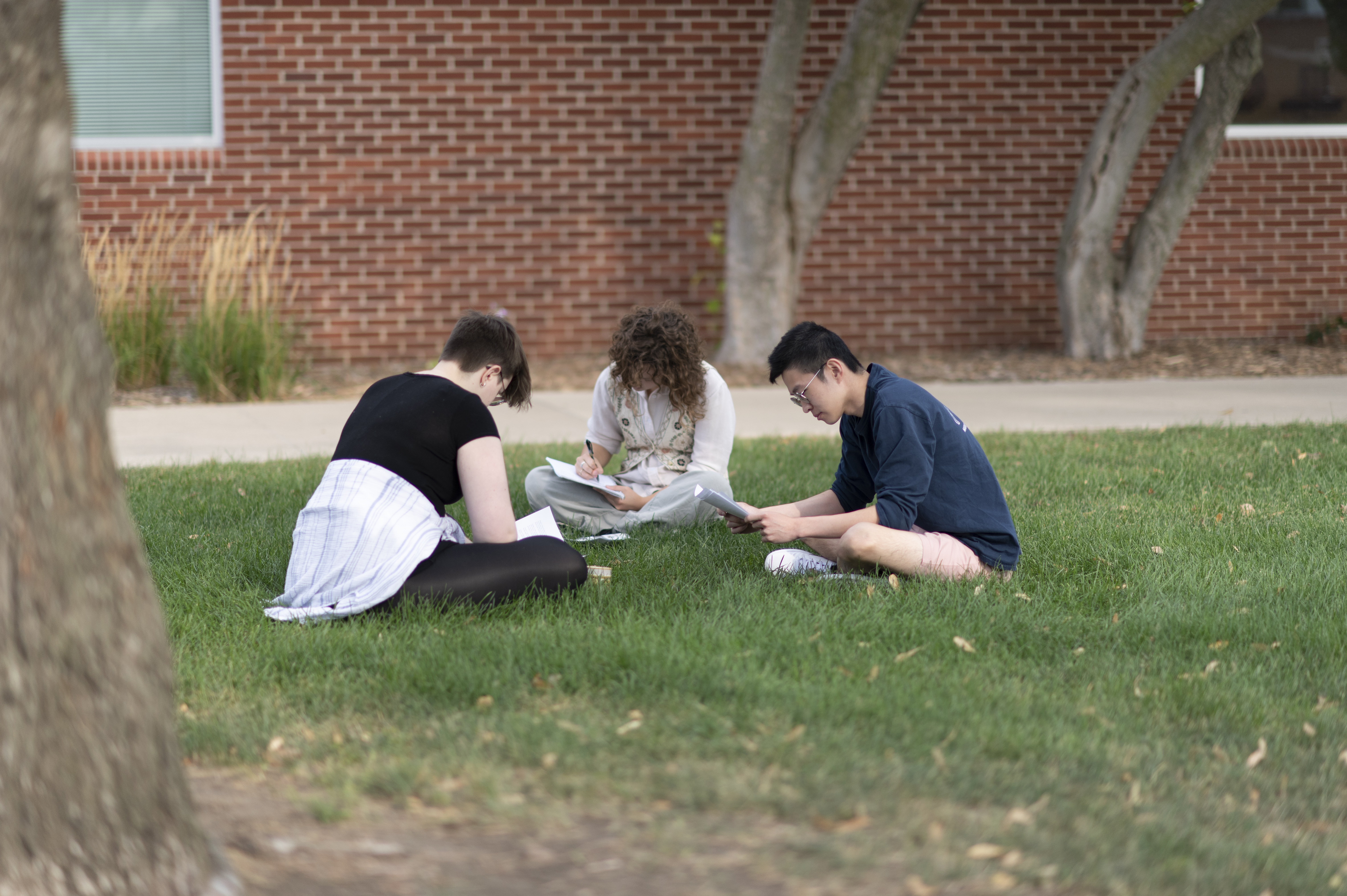 Students sit in a circle writing