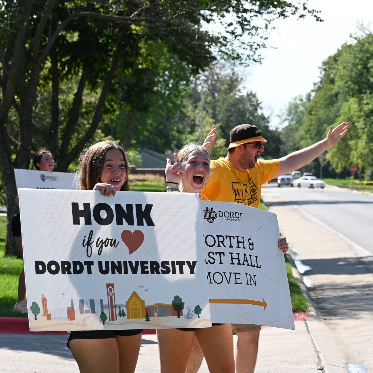 A picture of students waving and holding a move in sign during week of welcome