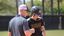 Softball coach coaches player