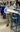 A picture of a man in a light blue shirt standing next to machinery