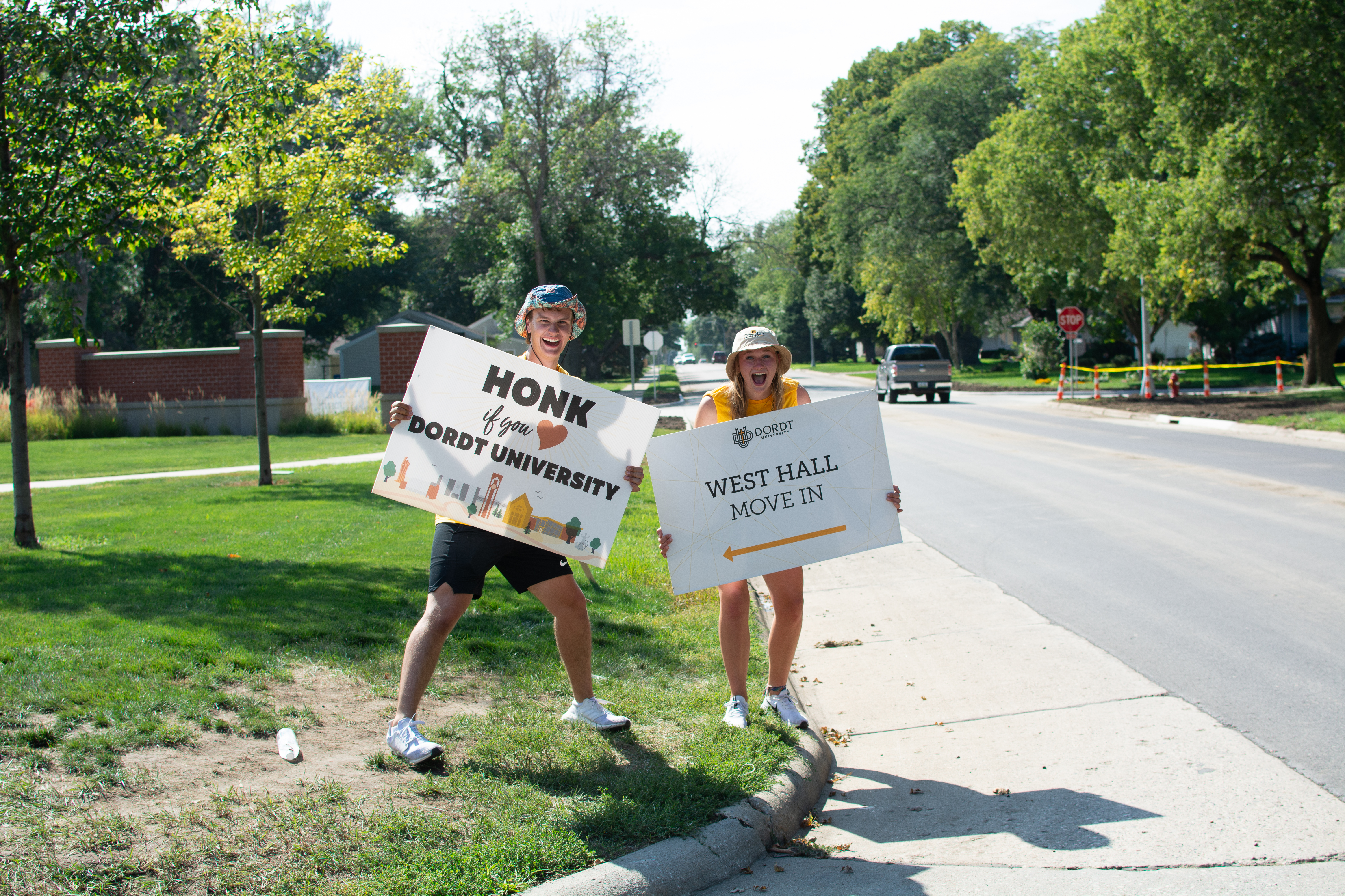 Students holding up signs
