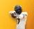 Football player pointing at camera with bold gold background and superimposed text