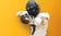 Football player pointing at camera with bold gold background and superimposed text