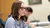 A female Dordt student with glasses sitting down looking forward paying attention to a lecture