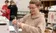 A nursing student prepares an IV bag in a nursing class