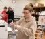 A nursing student prepares an IV bag in a nursing class