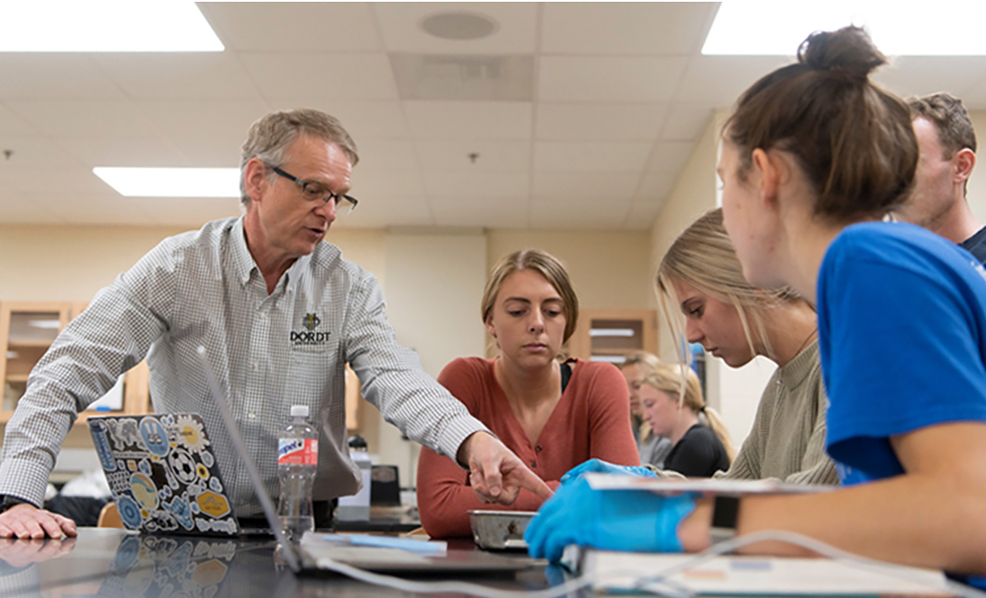 A Dordt Professor helping students with a question