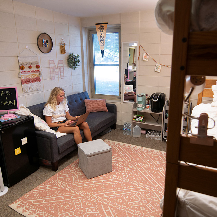 a Dordt student sitting in her dorm room studying