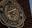 A picture of the old Dordt College seal on a brick structure.