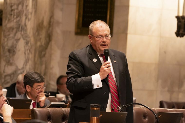 A picture of Terry Katsma speaking in front of an assembly