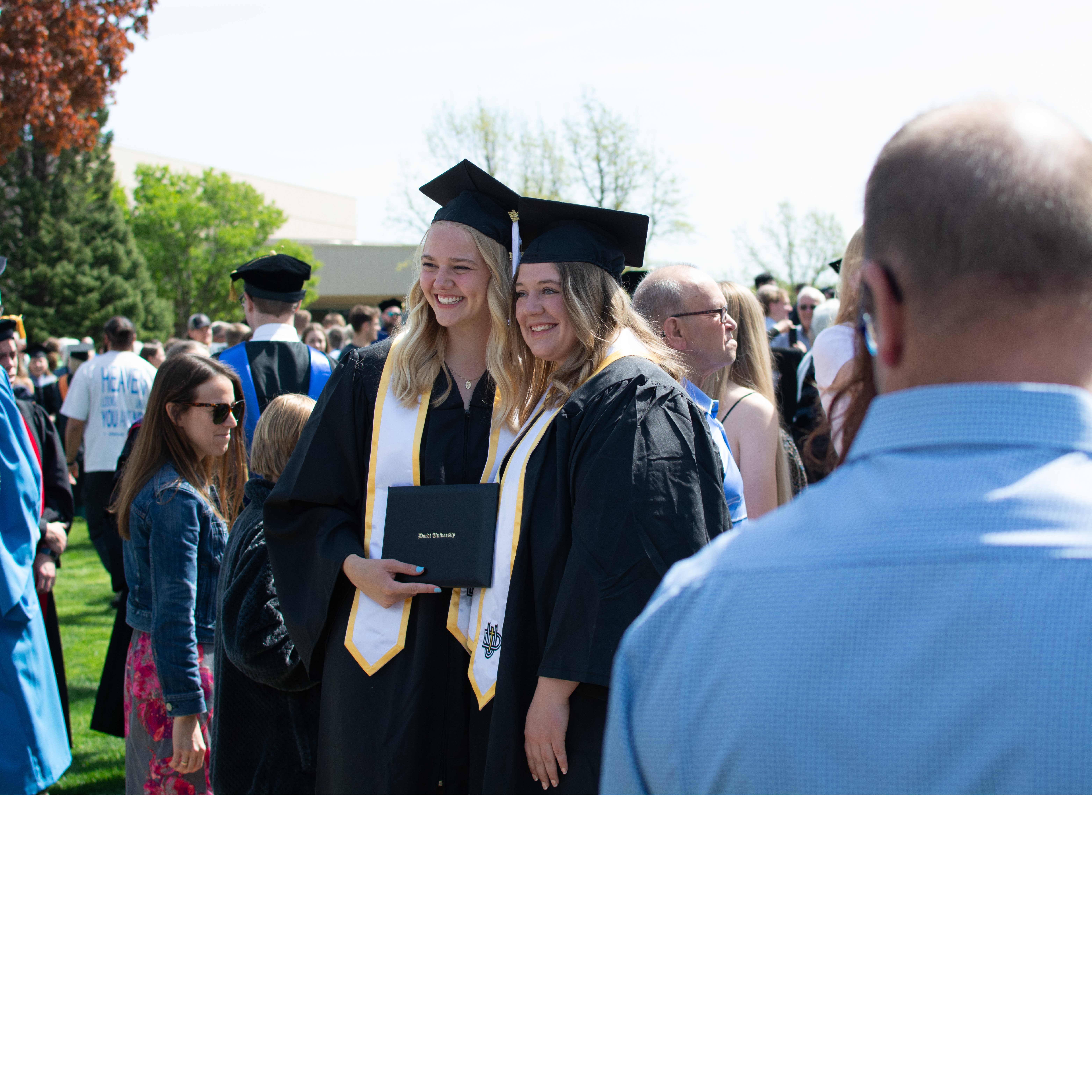 Friends smiling at graduation