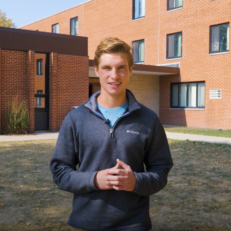 A Dordt student talking in front of a building