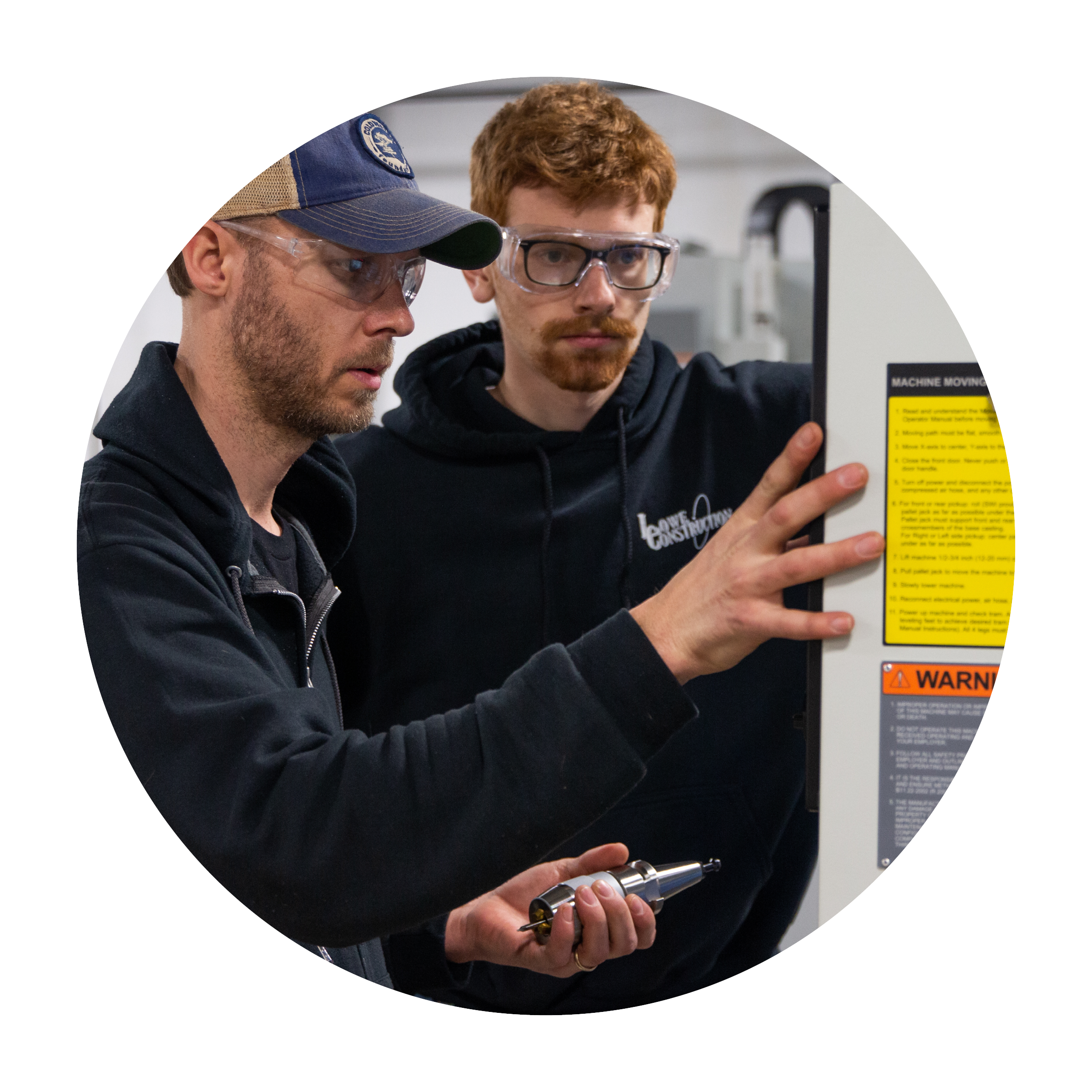 circle photo of two students working in goggles